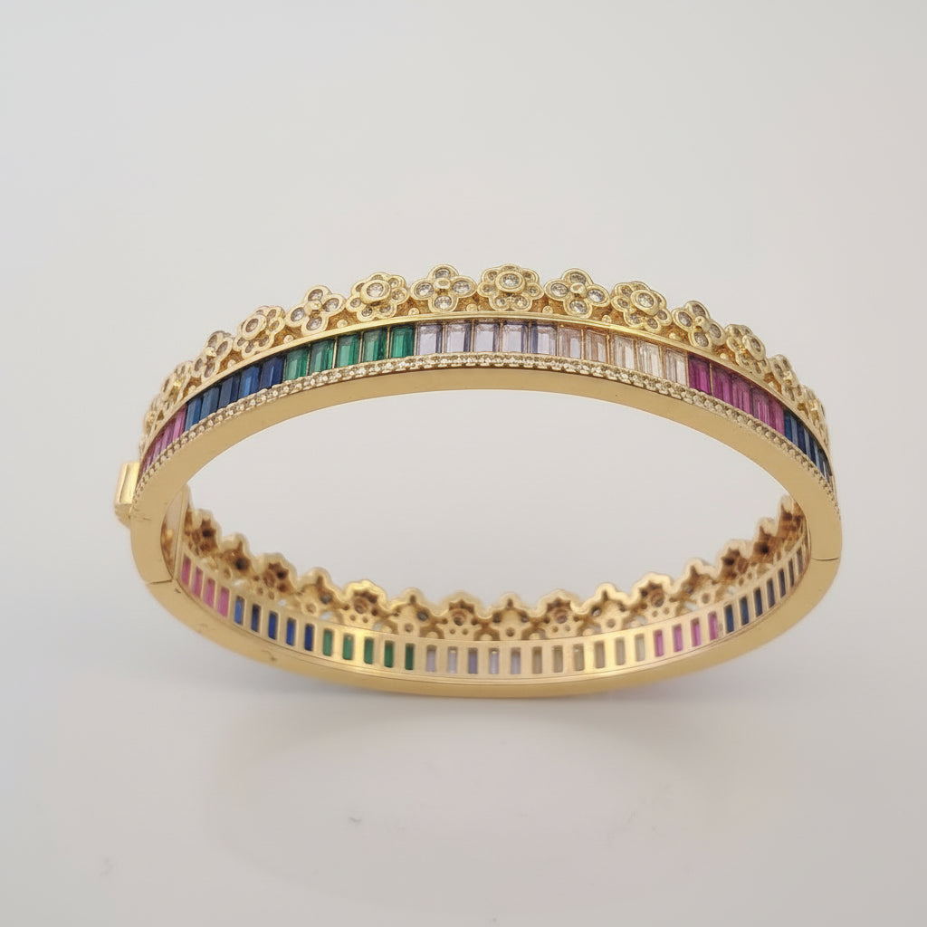 Gold bracelet with colorful stones on a white background