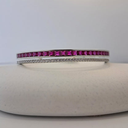 Bangle with pink gemstones on a white background