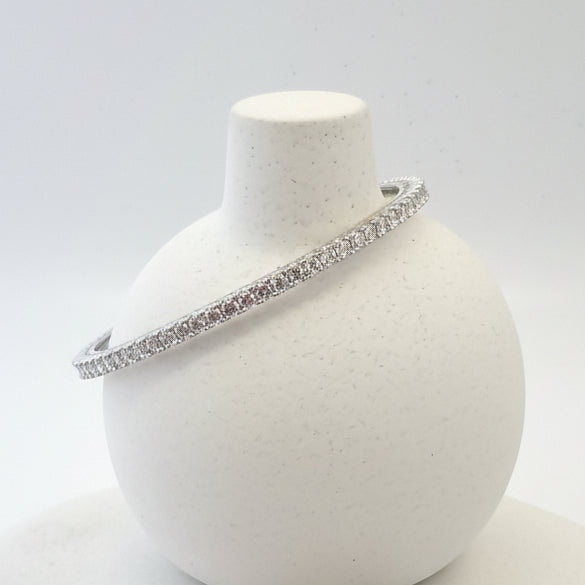 Silver bangles on a white background