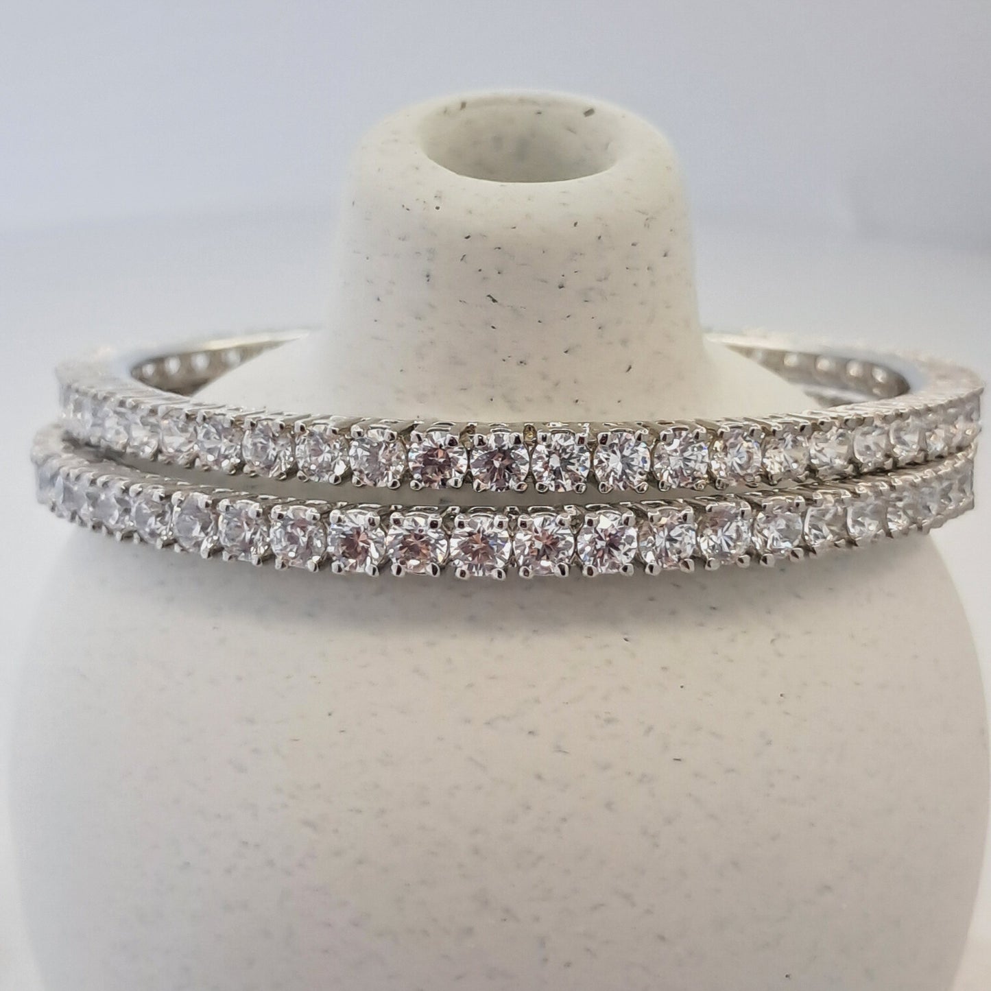 Silver ring with diamond accents on a white background