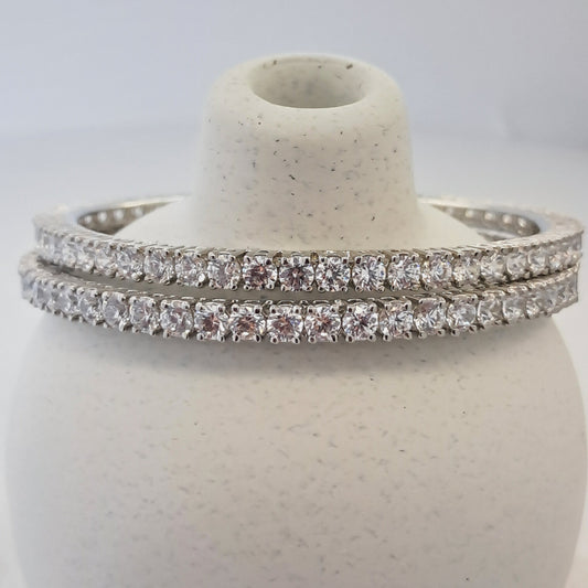 Silver ring with diamond accents on a white background