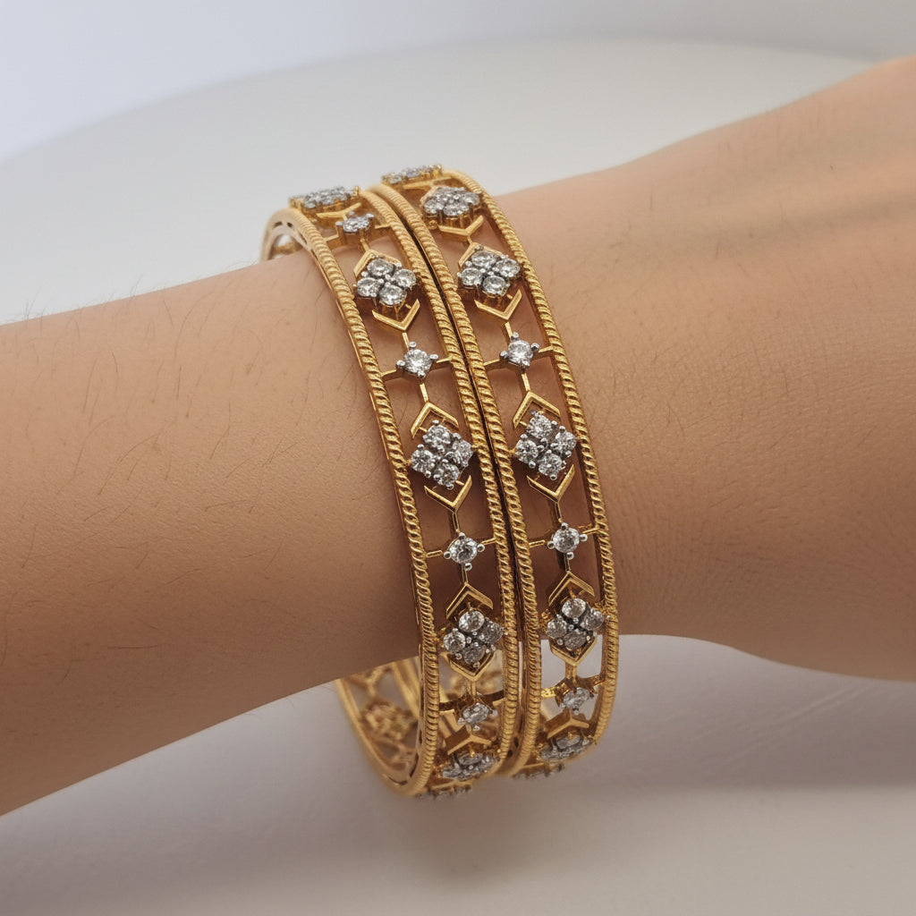 Gold bracelet with diamond-like stones on a white stand against a light gray background