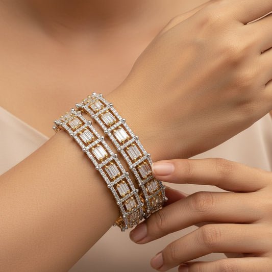 Gold bracelet with diamond accents on a white background