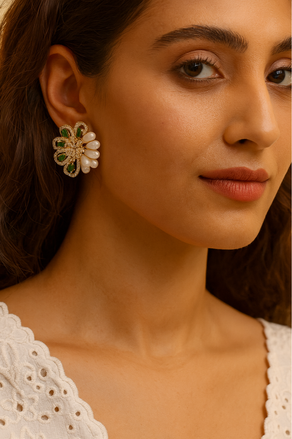 Close-up of a woman wearing a floral earring with a neutral background