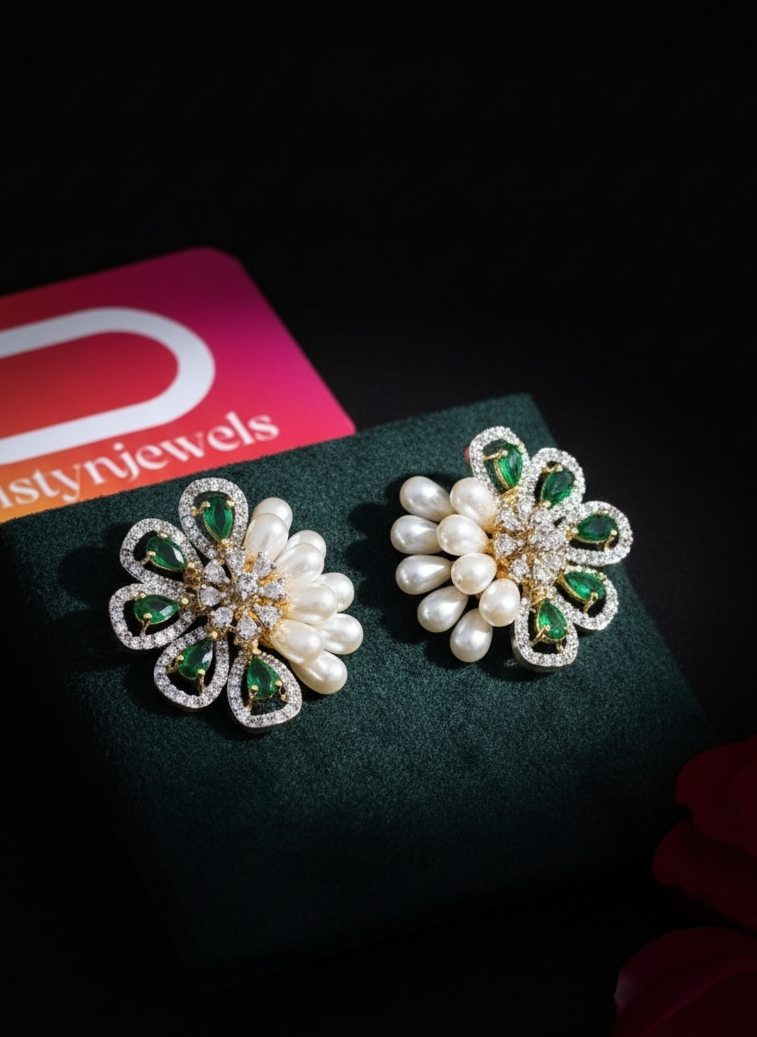 Pair of pearl and green gemstone earrings on a dark surface with 'Pristynjewels' branding.