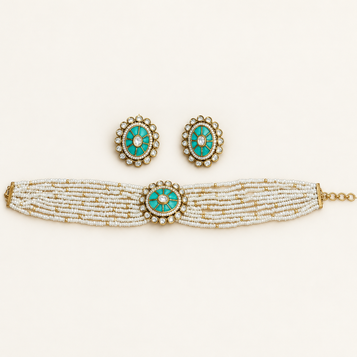 A traditional Indian jewelry set featuring a multi-strand beaded bracelet, matching earrings, and a necklace. The jewelry is decorated with white and gold beads, accented by oval turquoise inlay and small white stones.