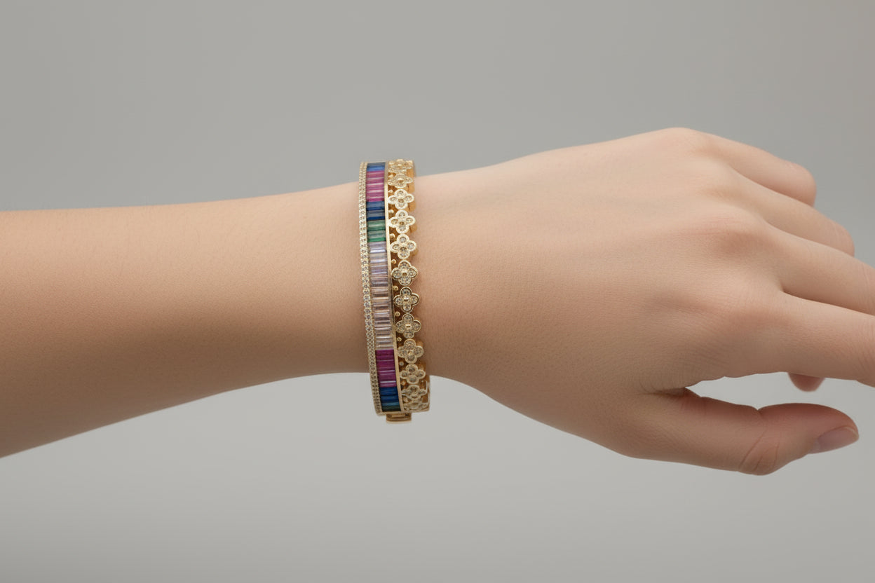 Gold bracelet with colorful stones on a white background