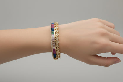 Gold bracelet with colorful stones on a white background
