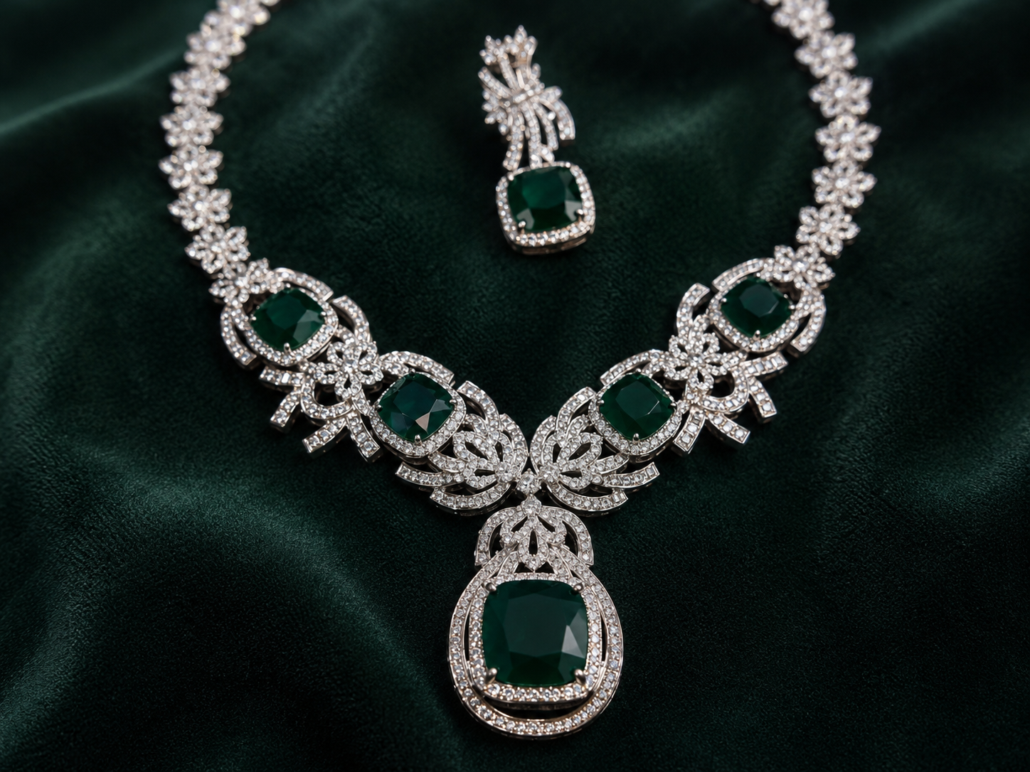 Luxury emerald green cubic zirconia statement necklace set with matching drop earrings for weddings, receptions, festive occasions, sarees and lehengas.