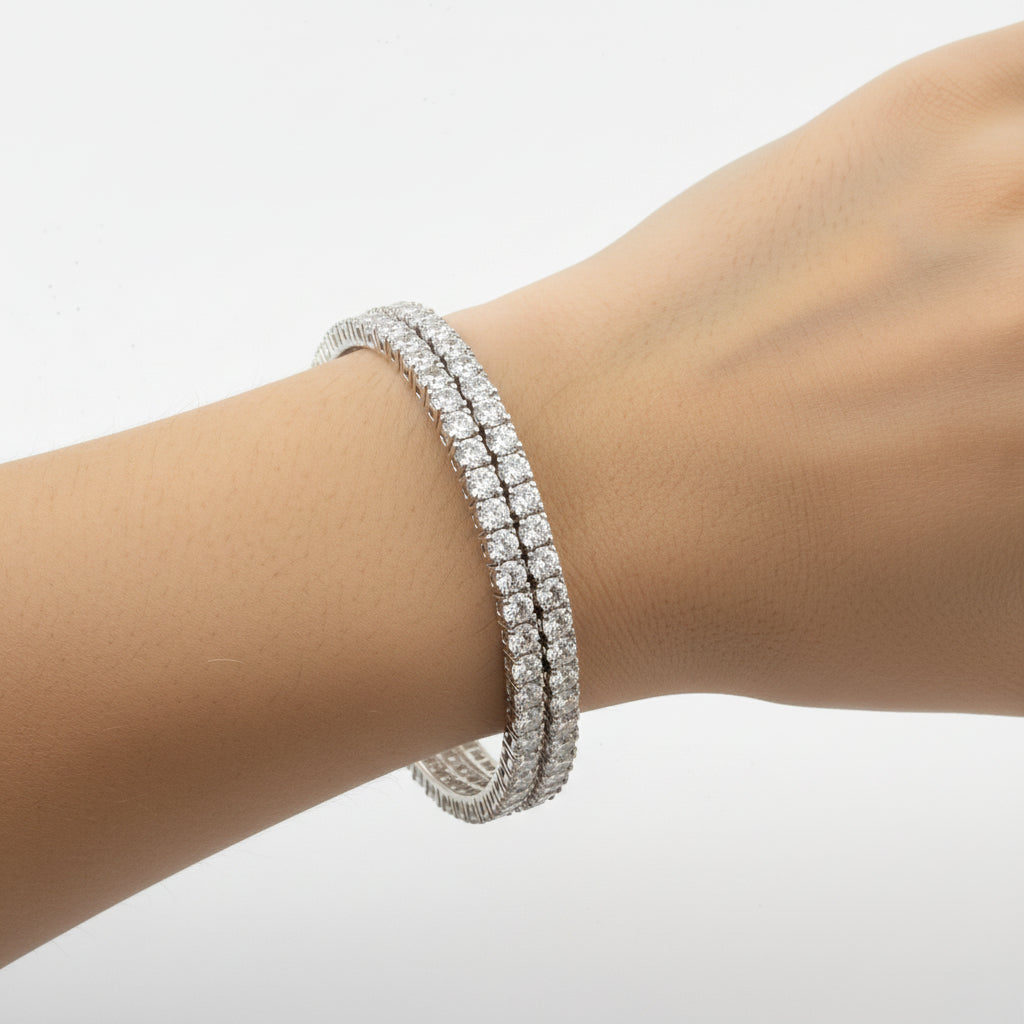 Diamond ring on a hand against a light gray background