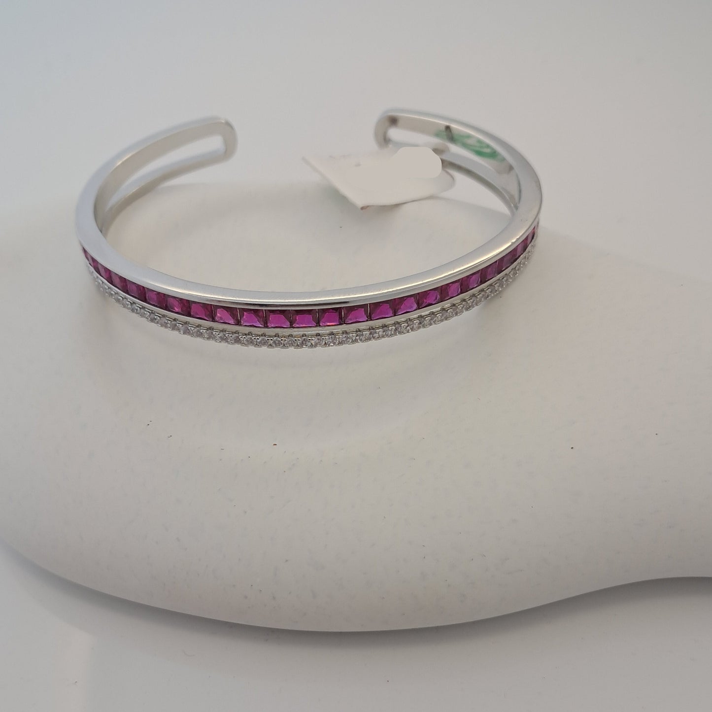 Silver bracelet with pink stones on a white mannequin arm