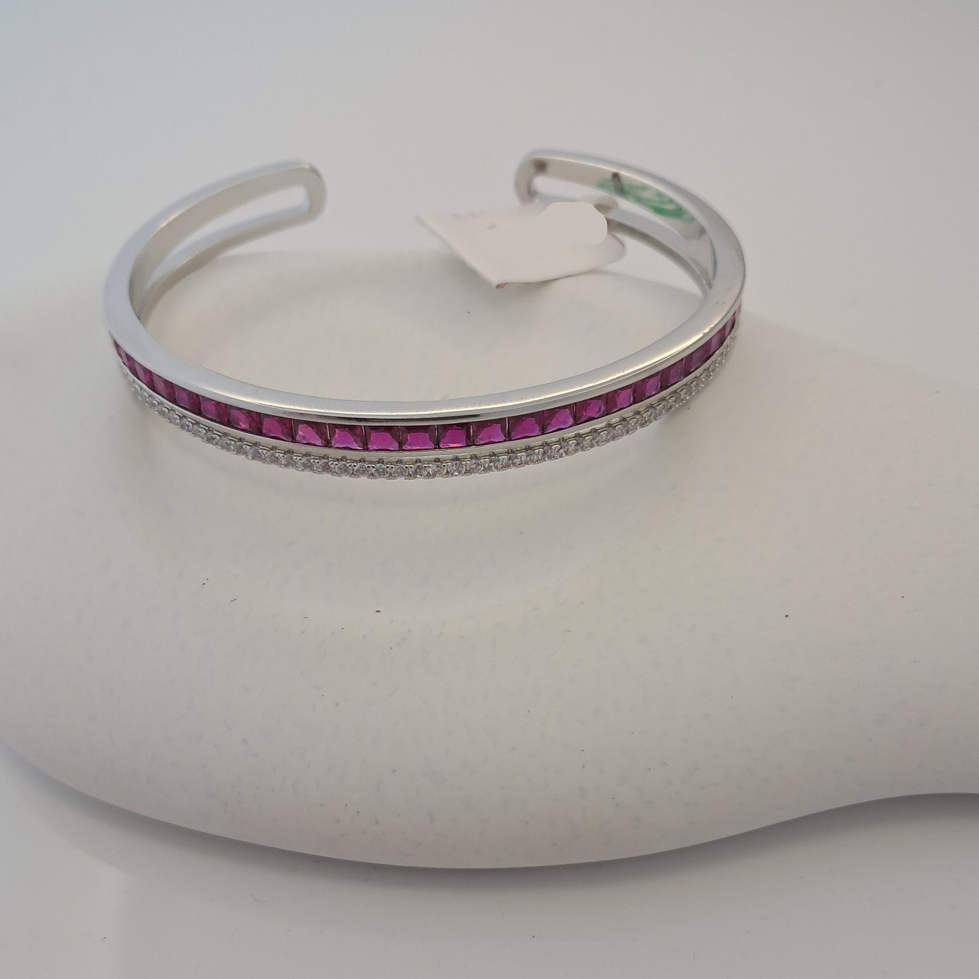 Silver bracelet with pink stones on a white mannequin arm